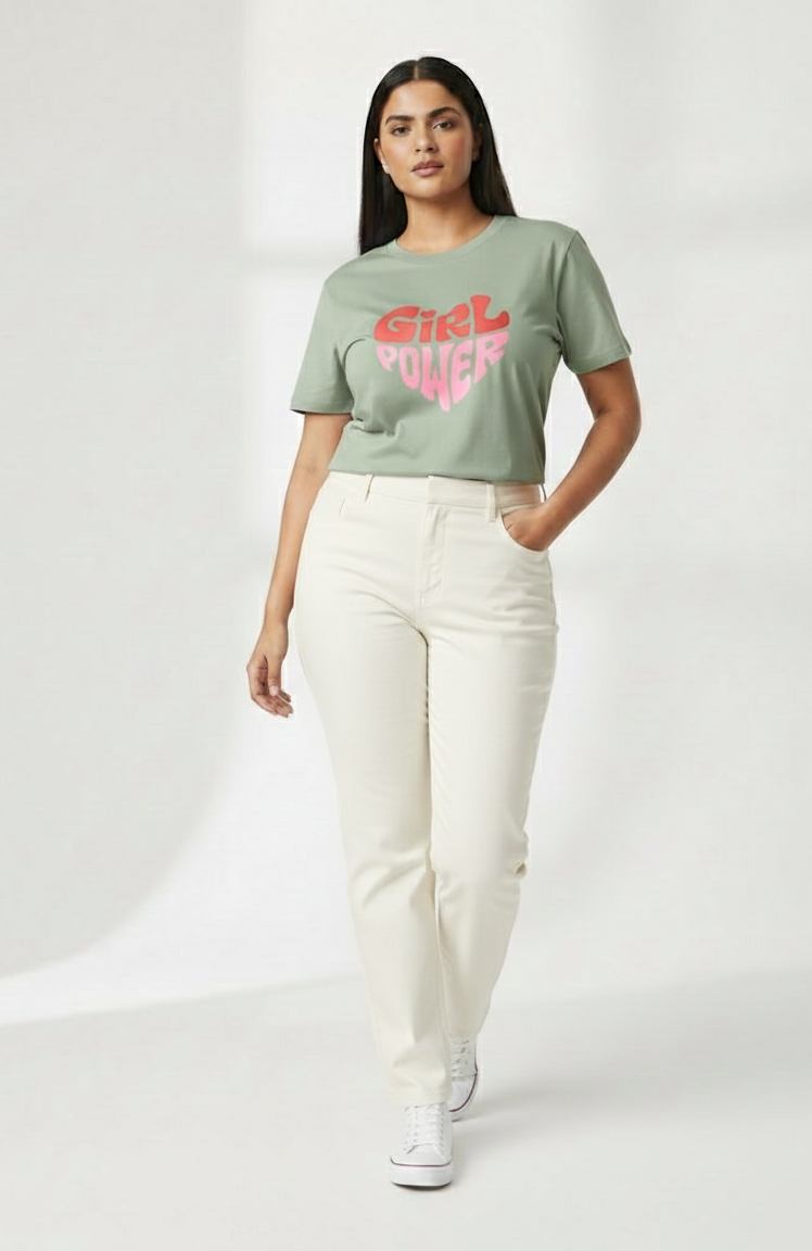 Woman wearing a green t-shirt with pink text and white pants on a white background